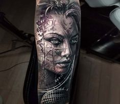 a woman's face with an artistic tattoo on her arm