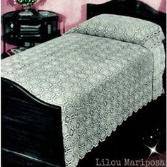 a black and white photo of a bedroom with a bed, night stand and nightstand