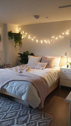 a bedroom with lights strung above the bed