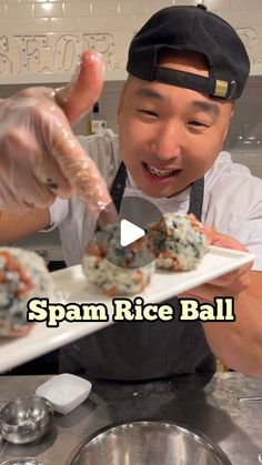 a man holding a plate with food on it in front of his face and the caption spam rice ball