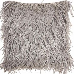 a gray pillow with fringes on the front and back of it, against a white background