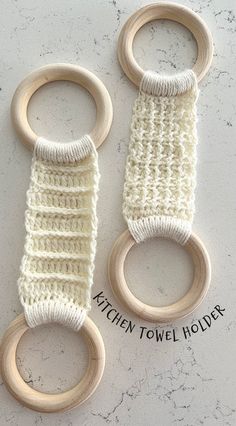 two crocheted wooden toys are sitting on a table with the words kitchen towel holders