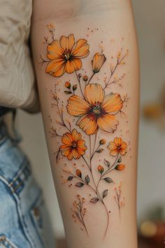 an orange flower tattoo on the right arm and leg, with yellow flowers growing out of it