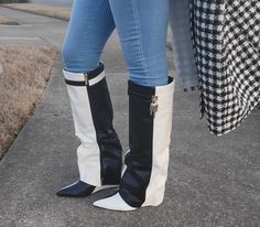 These statement boots will elevate your style to the next level. A faux leather material with padlock details and a wedge heel, this knee-high shoe is designed with a black and white faux leather material. Pointed Toe Heel Height: 4.5" Upper: 16" Calf Circumference: 14" Givenchy Boots, Statement Boots, Celebrity Boots, Luxury Boots, Wedge Heel Boots, High Shoes, Pointed Toe Heels, Celebrity Look, Nicki Minaj