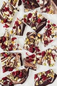 many pieces of chocolate with raspberries and nuts