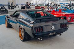 Screamer. This stunning 1970 #Ford #Mustang was built by the team at #TucciHotRods and debuted in the Toyo Treadpass display, at #SEMA2024. It's powered by a VMP Performance supercharged Super Cobra Jet 5.4L V8 and rides on QA1 Motorsports suspension, Wilwood disc brakes, Toyo tires, and 19x11/19x12 #Forgeline forged three piece #AL308 wheels finished with custom silver centers and custom gold outers! See more at: https://www.forgeline.com/customer-gallery-tucci-hot-rods/cgk2818