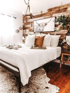 a white bed sitting in a bedroom next to a wooden wall