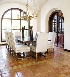 the dining room table is surrounded by white chairs