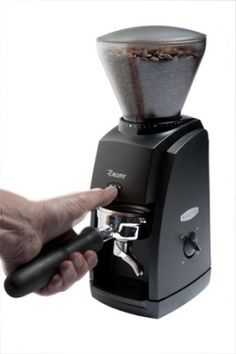 a person is using a coffee grinder on a white background