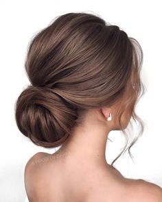 a woman with her hair in a low bun