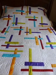 the quilt is made with strips of different colors