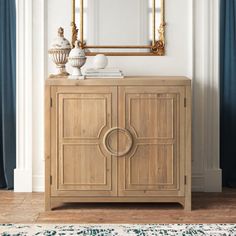 a wooden cabinet sitting in front of a mirror on top of a wall next to a rug