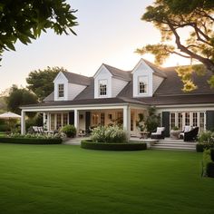 a large white house sitting on top of a lush green field