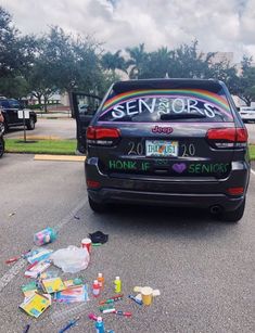 a car parked in a parking lot with the word seniors painted on it's back