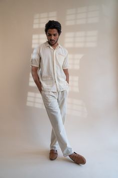 This Dawning Pleated Pants comes in a calm and soothing color. This 30s cotton pant is undyed and unbleached. Flattering mid-waist design with a straight-fit silhouette. Practical touches include side pockets, button-down fly, and belt loops. The pockets and hem are highlighted with the stitches of Kantha, a form of Indian hand embroidery to bring character to the garment. *This item is a final sale and not eligible for returns or exchanges. *This item can take up to 14 business days to ship as Relaxed Cotton Pants With Straight Hem, Cream Cotton Cargo Pants With Pockets, Neutral Pants With Pockets And Straight Hem, Beige Summer Pants With Patch Pockets, Relaxed Straight Leg Cotton Pants, Casual Cotton Pants With Buttoned Pockets, Relaxed Fit Conscious Cotton Bottoms, Cream Straight Pants With Welt Pockets, Cream Cotton Relaxed Fit Cargo Pants