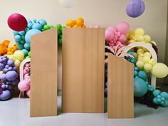 two cardboard doors are open in front of balloons