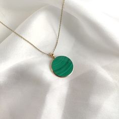 This stunning Pendant is set in 14k Solid Yellow Gold with Natural Malachite with utmost precision. It is a unique gemstone Pendant for nearly every occasion and is completely hassle-free jewelry. ITEM DETAILS: * Gem: Malachite * Gem Size: 20X20mm * Gem Shape: Round Flat Cut * Gem Weight: 18.29 carats * Gold Purity: 14KT * Gold Weight: 0.68 gram * Total Weight: 4.33 gram The Gold purity is guaranteed and it comes with authentic 14KT gold hallmark. Since my items are handmade, they are absolutely nickel and lead free. CUSTOMIZATION: * Gemstone customization is available and it can be substituted with a gem of your choice. Kindly message me for the same. PACKAGING * The Pendant comes with layers of safe and secure wrapping along with Free handmade jewelry box with every purchase. ➡️Head to t Green Onyx Round Gemstone Jewelry, Tarnish Resistant Green Round Jewelry, Green Tarnish Resistant Round Jewelry, Green Onyx Gemstone Jewelry, Yellow Gold Green Onyx Gemstone Jewelry, Green 14k Gold Necklace, Tarnish Resistant, Green 14k Gold Necklace Tarnish Resistant, Yellow Gold Malachite Pendant Jewelry, Gold Malachite Jewelry For May Birthstone