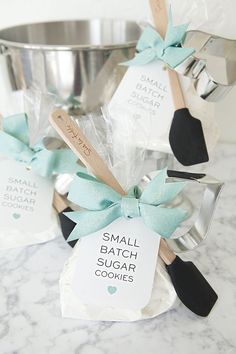 small batch sugar cones with wooden spoons and tags on them sitting in front of a metal bowl