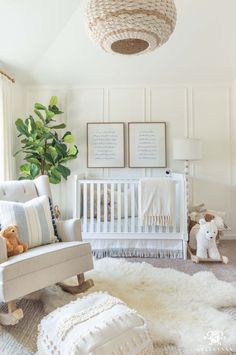 a baby's room with white furniture and decor