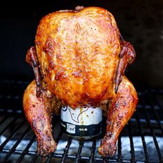 a whole chicken is cooking on the grill