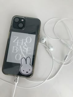 an iphone case with earbuds and headphones attached to the back of it