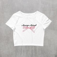 "Introducing our elegant \"Marriage Material\" white crop top, adorned with a charming pink bow - the ideal garment for any bride-to-be. This stylish and playful top is the perfect gift for engagements, bridal showers, or bachelorette parties, adding a touch of joy to the pre-wedding celebrations. Embrace the spirit of the occasion with this delightful crop top, designed to make any bride extra special. Celebrate love in style with this chic and unique addition to the bride's wardrobe.  Product details: 🎀 * 52% combed ring-spun cotton, 48% polyester * Fabric weight: 3.6 oz/yd² (122 g/m²) * XS/SM, M/L * Slim fit * Side-seamed construction * Blank product sourced from Nicaragua, the US, or Honduras This product is made especially for you as soon as you place an order, which is why it takes Fitted Bow Crop Top, Fitted Cropped Top With Bow, Feminine White Crop Top For Wedding, White Feminine Crop Top For Wedding, Fitted White Crop Top With Bow, Feminine Cotton Crop Top For Parties, White Cotton Top With Pink Bow, Cute White Top With Pink Bow, Bachelorette Glitz And Glam