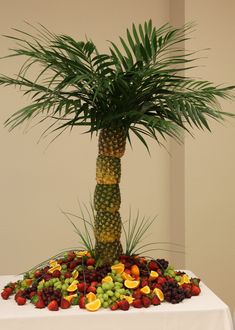 a palm tree made out of fruits on a table