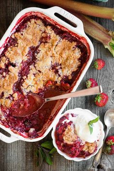 berry cobbler with ice cream and strawberries on the side, ready to be eaten