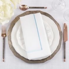 a place setting with napkins and silverware