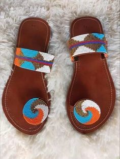 Our Maasai Sandals are handmade by talented artisans ("fundis") in Kenya, East Africa. Made from 100% original African fine beads, the colorful designs are usually created by skilled women, who weave intricate designs with the use of fishing wire. The inside leather sole and outside rubber sole are cut by hand using a pattern. Known to be very comfortable, one can wear these sandals with absolutely anything, as they will complement any outfit. We offer variety of sizes. Kindly select your size while placing your order or send us message with your shoe size.If you are deciding between two sizes we recommend choosing the larger one. We also recommend measuring the length of your feet and ordering a size that is 0.4 (1 cm) longer. After placing your order, we'll request you to give us three d Leather Chappals, Beaded Leather Sandals, Open Shoes, Afrikaanse Mode, Beautiful Sandals, Beaded Sandals, Maasai, Leather Sandals Women, Palm Beach Sandals