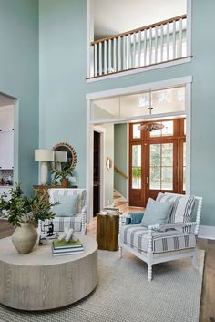 a living room with blue walls and white furniture