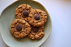 four cookies with chocolate chips on a plate