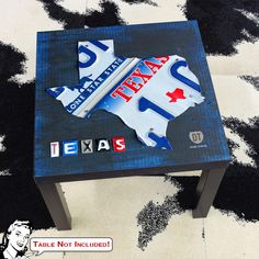 the texas state shaped table is made out of letters and stickers that spell it's texas