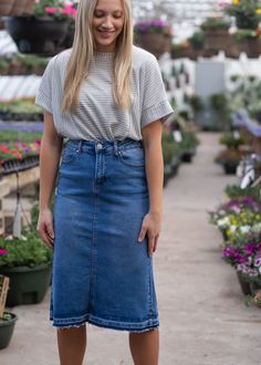 The Marley A-line Midi Denim Skirt is just as sweet as it sounds! This a-line skirt is adorned with a raw hem and four functioning pockets. A button front closure and a small back slit for ultimate walkability! It is a medium wash denim that can be worn any day, all year long! Care Tag