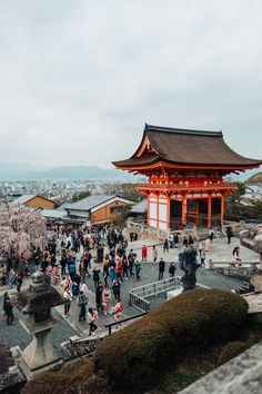 many people are walking around in front of a building