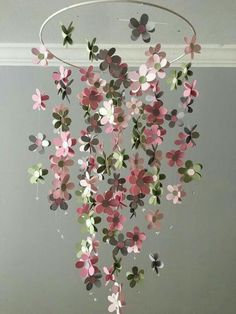 a mobile made out of paper flowers hanging from a ceiling