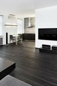 an empty living room with wood floors and white walls