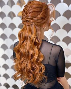 a woman with long red hair wearing a black dress and half - up hairstyle