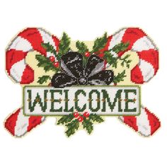 a welcome sign with candy canes and holly leaves on it's border, in the shape of a cross stitch