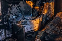 an old stove in the middle of a burned out house with lots of fire damage