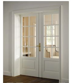 an open white door with glass panels