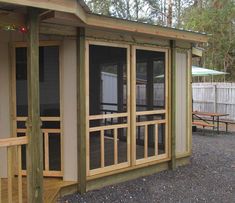 a small wooden building with sliding glass doors