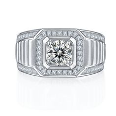 a white gold and diamond ring with an intricate design on the center, surrounded by small diamonds