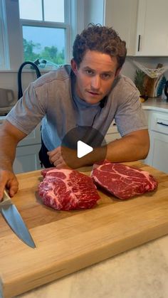 a man cutting up meat on top of a wooden cutting board