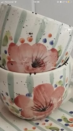 two bowls with flowers painted on them