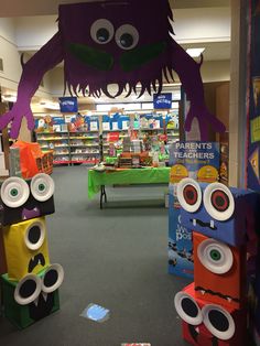 an open book store with bookshelves and decorations in the shape of monster heads