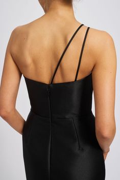 the back of a woman wearing a black dress