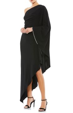 A study in elegant extremes, this high-drama dress delivers an exposed shoulder balanced by a twinkle-trimmed batwing sleeve on the other side. 46" length One-shoulder neck Single long sleeve Lined 100% polyester Spot clean Imported Short Wedding Guest Dresses, Cape Sleeve Dress, Formal Wedding Guest Dress, Long Cape, Formal Dresses Gowns, Party Dress Long Sleeve, Cape Sleeves, Short Cocktail Dress, Rhinestone Trim