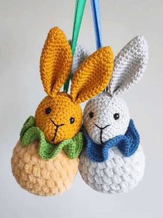 two crocheted stuffed animals hanging from strings