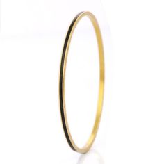 This is part of Chairish’s Fine Jewelry assortment.  Black Enamel Bangle in 18K Gold. It’s a great jewelry ornament to wear on occasions and at the same time works as a wonderful gift for your loved ones. These lovely statement pieces are perfect generation jewelry to pass on. Bangles feel comfortable while wearing it as it is lightweight, designer and skin friendly. Our handmade solid gold bangles are a stylish accessory which is perfect for your daily casual wear or work formal wear.  PRODUCT DETAILS :-  > Material - 18K Solid Yellow Gold > Gross Weight - 11.89 grams > Length - 62.5 mm  > Width - 2.5 mm Classic 22k Yellow Gold Bracelets, Elegant 14k Gold Jewelry With Black Enamel, Classic 22k Yellow Gold Bracelet, Classic 22k Gold Bracelets For Formal Occasions, Classic 22k Gold Bracelet For Formal Occasions, Timeless Hallmarked Bangle Jewelry, Gold Jewelry With Black Enamel For Anniversary, 22k Gold Bracelets For Formal Occasions, Timeless Black Enamel Jewelry As Gift